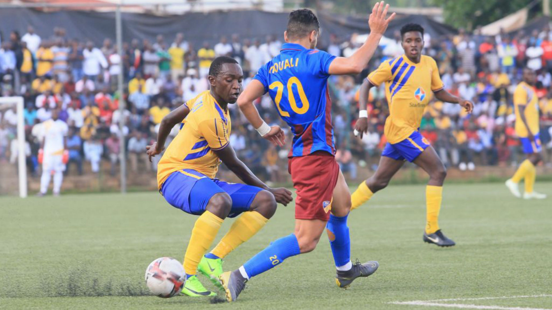 nicholas kasozi of kcca fc wins possession from paradous hamza mouali in the caf confederation