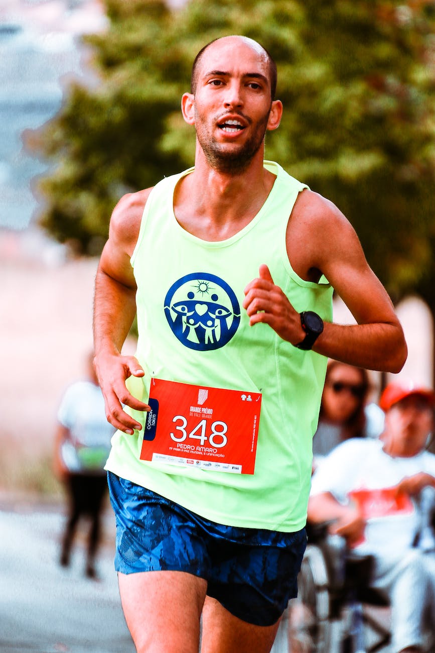 shallow focus photo of man in active sports wear running