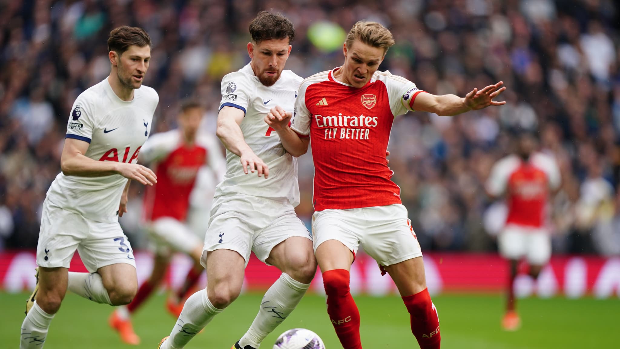 Tottenham Hotspur s Pierre Emile Hojbjerg centre left and Arsenal s Martin Odegaard battle for the ball during the Premier League match at the Tottenham Hotspur Stadium 1852885